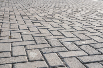 A close-up image of a brick pavement, showcasing the intricate pattern and texture of the bricks. Ideal for design projects, backgrounds, or construction-related content.