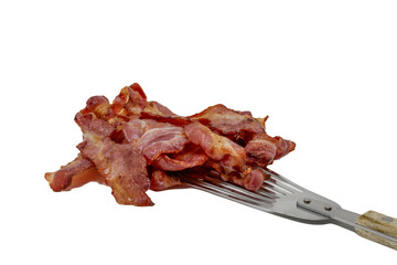 Rashers of crispy cooked streaky bacon on a slotted turner isolated against a white background