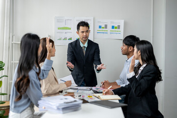 The man is giving a presentation and the group of people are listening intently
