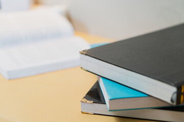 Stack of Hardcover Books on a Wooden Table