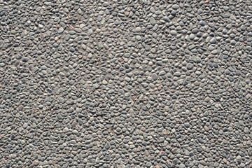 A high-resolution image of a seamless texture of small grey pebbles embedded in concrete. Perfect...