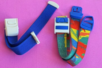 two different multi-colored and blue elastic for stopping bleeding patches on arm or leg medical...