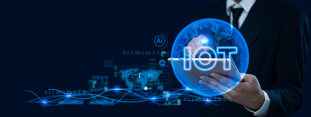 Businessman holding a digital globe with IoT concept graphics, representing technology, innovation, and global connectivity.