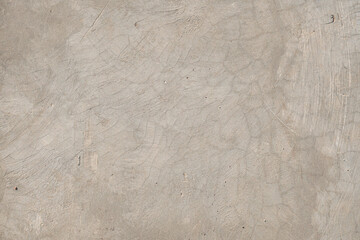 Close-up of a weathered concrete surface with subtle cracks and textured lines, offering a natural, raw finish. Ideal for backgrounds, construction themes, or industrial design concepts