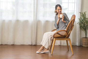 Portrait of smiling happy enjoy beauty asian woman relax drinking cup of hot coffee or tea,Cappuccino,Espresso,Americano,Latte.Girl felling enjoy breakfast in holiday morning vacation on bed at home