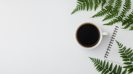 Coffee cup, notebook, and ferns on a white isolated background