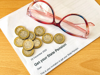 Offical letter telling a person of state retirement age in the UK they can get their pension, with...