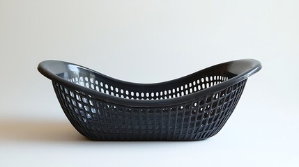 Fototapeta premium A black plastic basket, simple yet functional, stands isolated on a white background.
