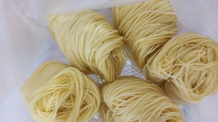 raw noodles on a white background. close up view of delicious asian food. 