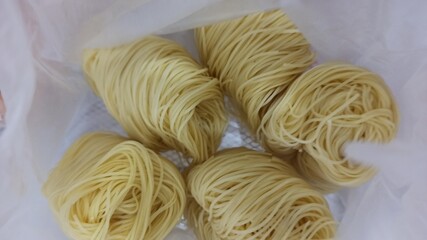 raw noodles on a white background. close up view of delicious asian food. 
