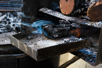 close up of grill shovel with embers, barbecue
