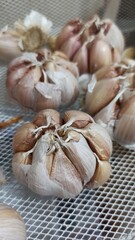 Garlic and onion in plastic bag for sale at local market. Garlic in the market. Selective focus and shallow depth of field.