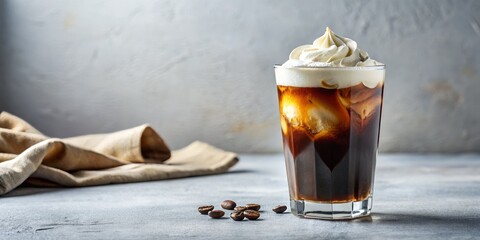 A glass of cold brew coffee with a subtle vanilla note and a generous dollop of cream rests on a pure white surface, illuminated by soft, diffused light, exuding a mood of calmness and refinement.