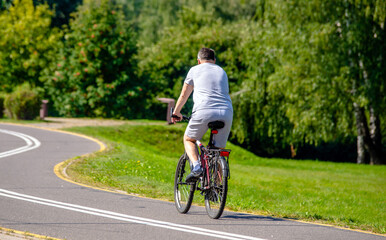 Fototapeta premium Cyclist ride on the bike path in the city Park 