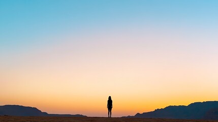 Fototapeta premium Silhouette of a Person Against a Sunset Horizon