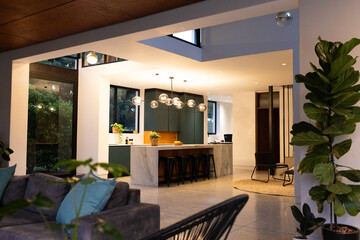 Modern kitchen with marble island and bar stools in stylish open-plan home, copy space