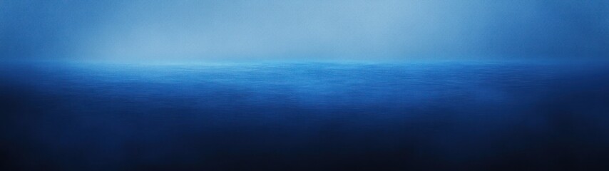 Obraz premium A serene blue ocean horizon blending into a misty atmosphere.