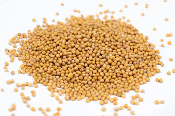 Mustard seeds on white background, natural organic seasoning