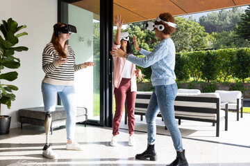 Using VR headsets, diverse women friends enjoying virtual reality experience together