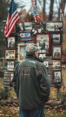 Fototapeta premium Veteran Reflecting on Military Service at Outdoor Veterans Day Display with Flags and Memorabilia