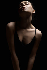 Sexy Woman silhouette in dark. Beautiful Body Girl over black background