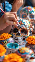 Fototapeta premium Artist Painting Colorful Sugar Skulls with Marigolds, Celebrating Day of the Dead - Ideal for Posters or Cards