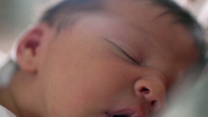 Extreme close-up of newborn’s eye area while sleeping, with soft light creating a dreamy effect,...