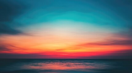 A stunning sunset horizon with blurred colors, blending warm and cool tones across the sky in a dynamic, peaceful visual gradient