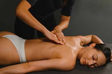 Fototapeta premium Masseur doing massage on woman body in the spa salon. Beauty treatment concept