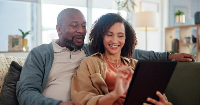 Mature couple, tablet and happy on couch with reading, relax and choice for movie, streaming or funny meme. People, man and woman with interracial love, touchscreen and app for social network in home