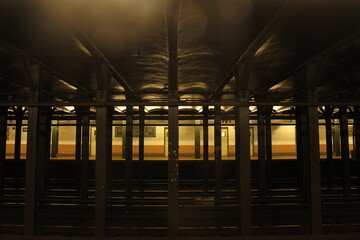 Manhattan subway station at night with atmospheric lighting