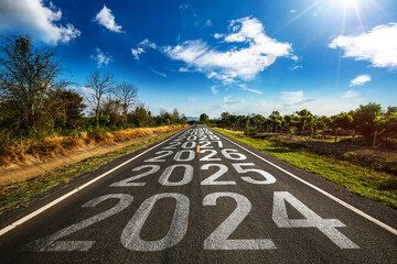 2024-2030 written on highway road in the middle of empty asphalt road and beautiful blue sky. Concept for vision 2024-2030.	