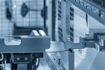 The high technology material handling at press brake bending machine by automatic robotic arm in the light blue scene.