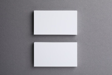 Fototapeta premium Blank business cards on grey background, top view. Mockup for design