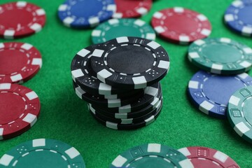 Group of poker chips on green table, closeup