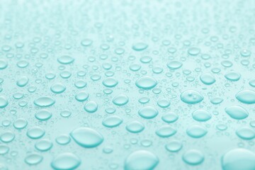 Water drops on turquoise background, closeup view