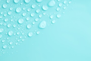 Water drops on turquoise background, top view. Space for text