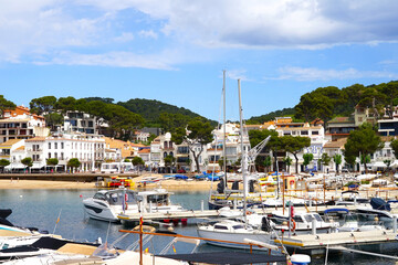 boats and yachts in the port of Llafranc, beach and promenade of the village behind, Costa Brava, Girona, Catalonia, Spain