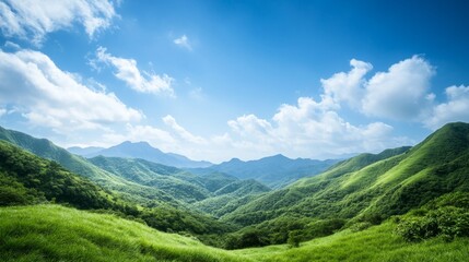Fototapeta premium Breathtaking panoramic view of lush green hills under a serene blue sky