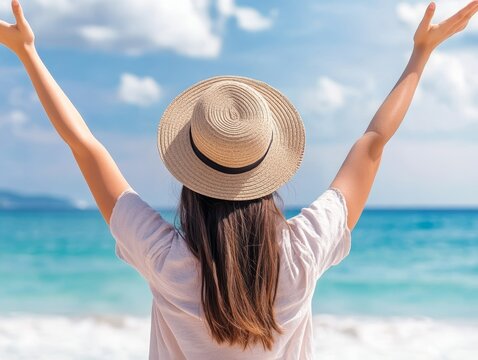 Carefree Woman Relaxing with Arms Raised on Scenic Beach with Ocean Views