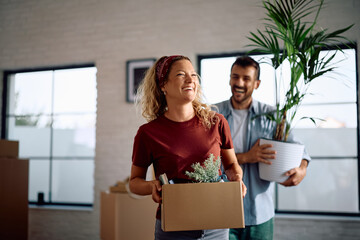 Happy woman and her husband relocating into new apartment.
