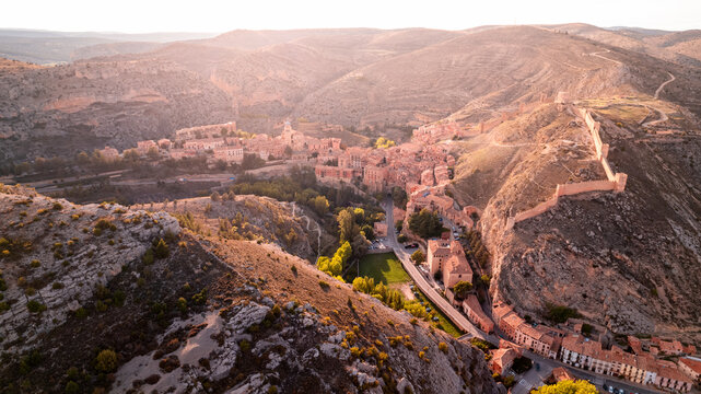 Drone photograph of the castle of Albarrac&iacute;n, crowning the town on its hill. An aerial image showing its fortified structure surrounded by the famous wall and the natural environment.
