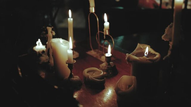 The soft, flickering light of a gentle candle creates an inviting atmosphere on a darkened table