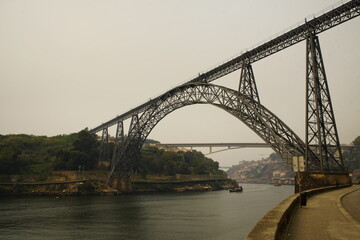 The Ponte Maria Pia was the largest arched bridge in the world when it opened in 1877. Along with the Garabit Viaduct, it is Gustave Eiffel's most famous bridge. Douro river, Porto Portugal.