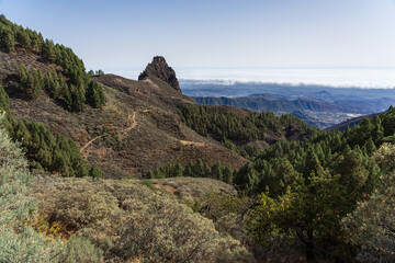 Typical mountain landscape in the center of the island, the rock in the background - Roque del Pino. Gran Canaria. Canary Islands. Spain.