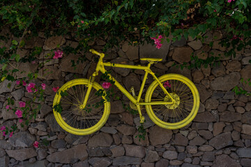 Old bicycles on a stone fence as decoration.