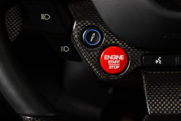 Start stop engine red button of a premium luxury super speed sports car.