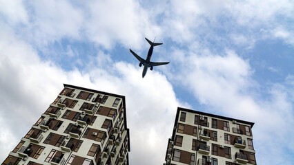 plane flies low over houses