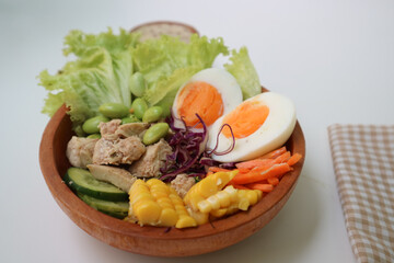 Chicken and vegetables salad with ingredients egg boiled, tomato, corn, edamame, carrot and grilled chicken. Served with sesame mayonnaise.