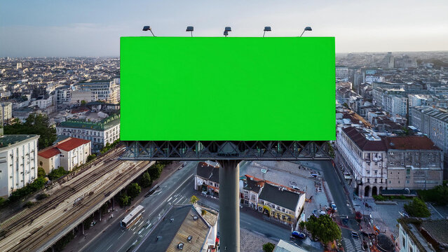 Large billboard against background of city street buildings skyline for advertising or promotion.